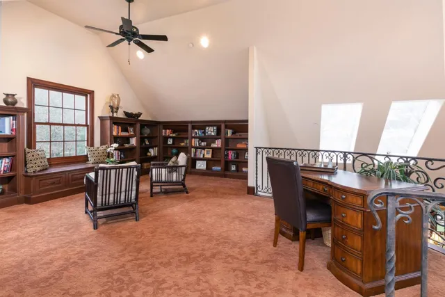 a view of a house with a big yard and large trees