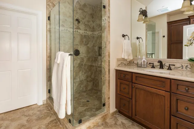 a front view of a house with a garden and trees