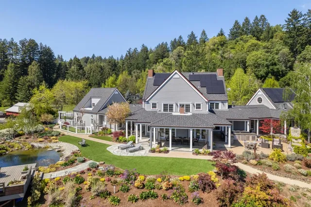 a backyard of a house with garden and outdoor seating
