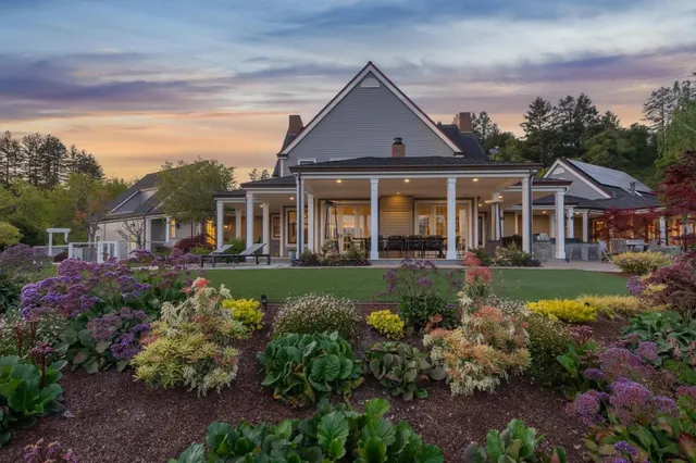 a front view of a house with a garden