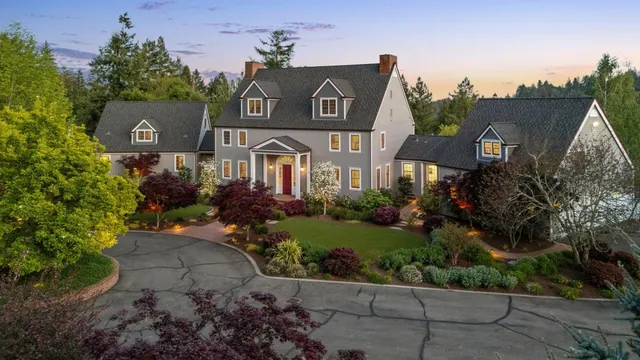 a kitchen with stainless steel appliances granite countertop a stove top oven a sink dishwasher a dining table and chairs with wooden floor