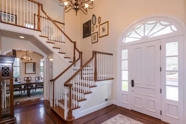 a living room with furniture fireplace and a large window
