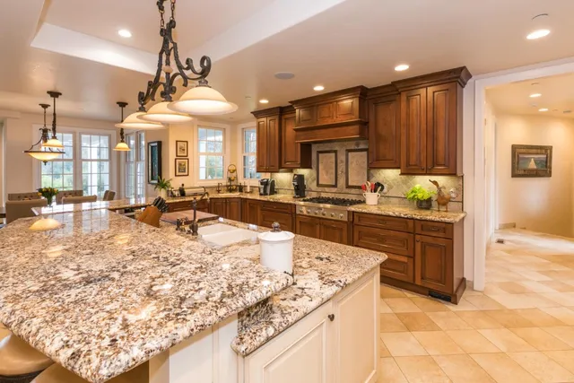 a living room with furniture a fireplace and a window