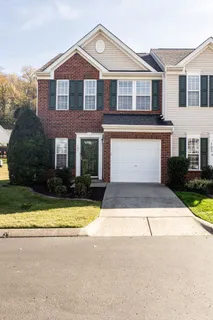 a front view of a house with yard and garage