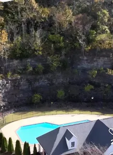 a view of a house with pool and chairs