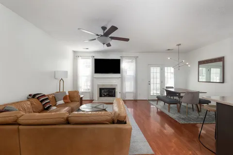 a living room with furniture a fireplace and a flat screen tv