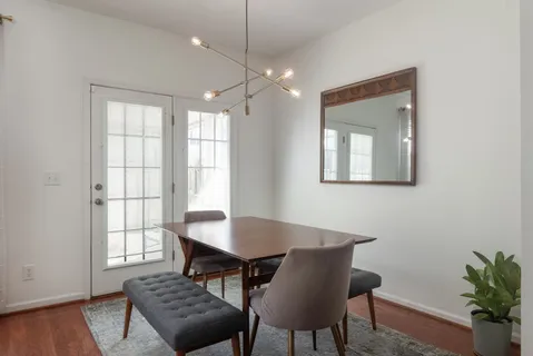 a view of a dining room with furniture and wooden floor