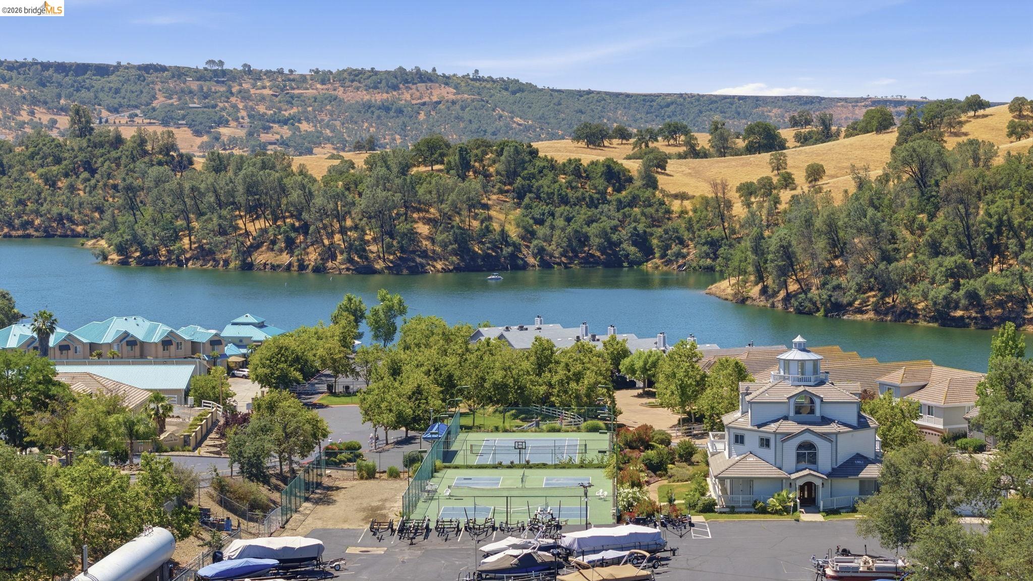 6242 Bluff View Road Copperopolis, CA 95228 - Photo 56 of 59 Expansive outdoor amenities featuring multiple tennis courts, pickleball and a large private parking area for boat, RV or trailer storage for HOA residents only as an optional monthly fee.