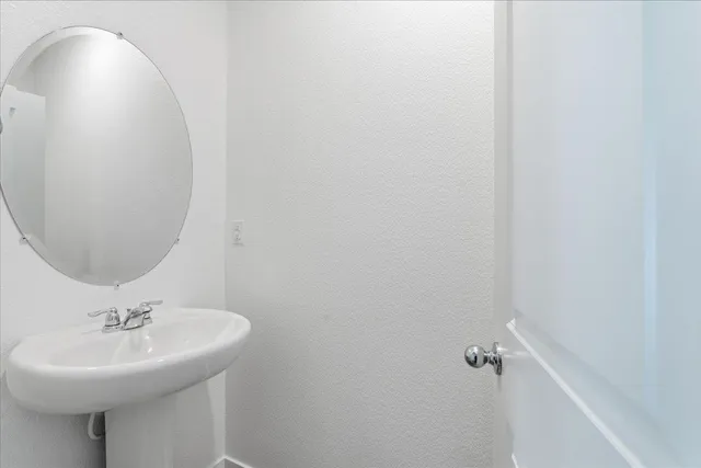 a bathroom with a sink a mirror and vanity