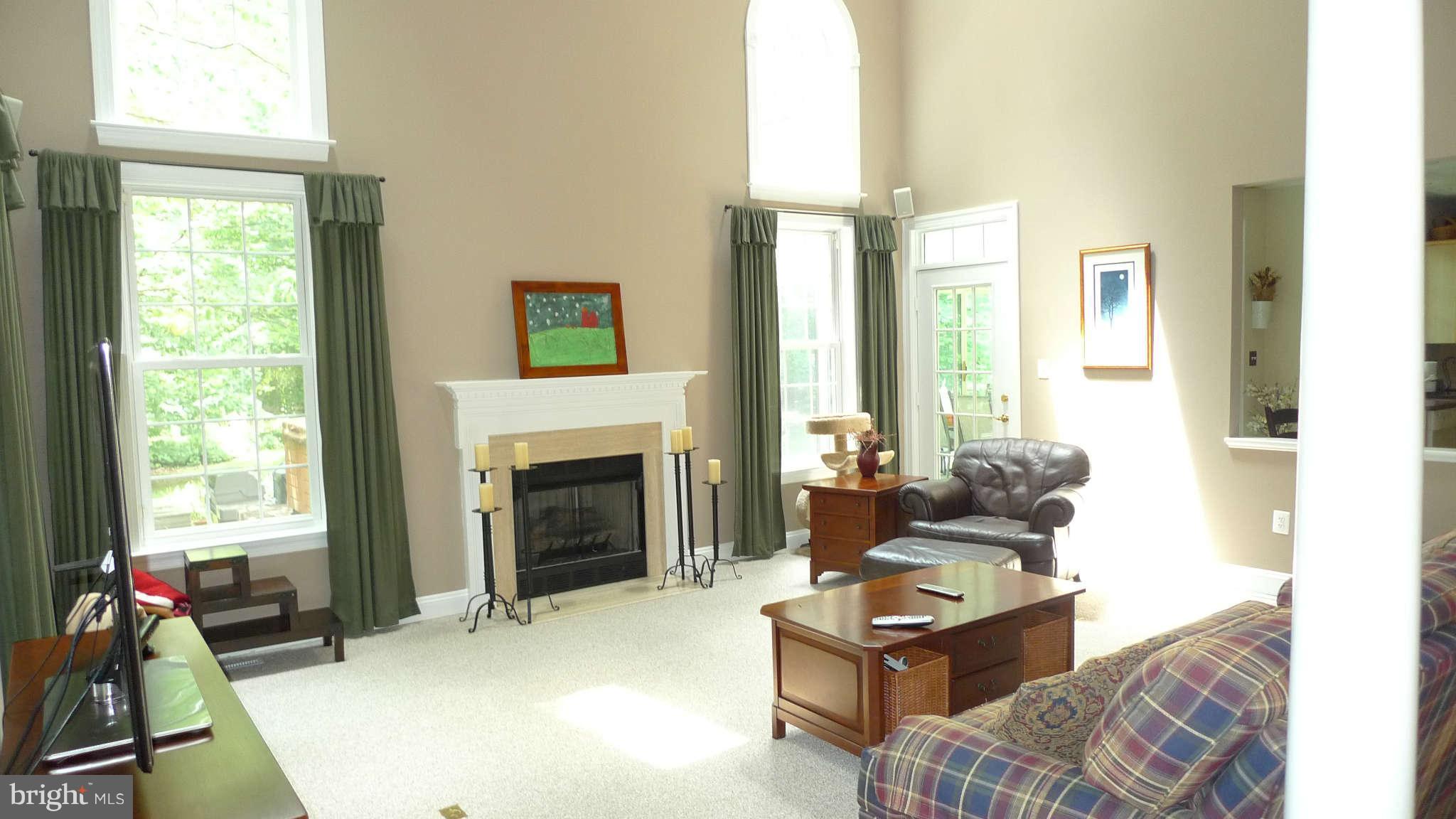 3366 Basford Road Frederick, MD 21703 - Photo 11 of 30 a living room with furniture a large window and a fireplace