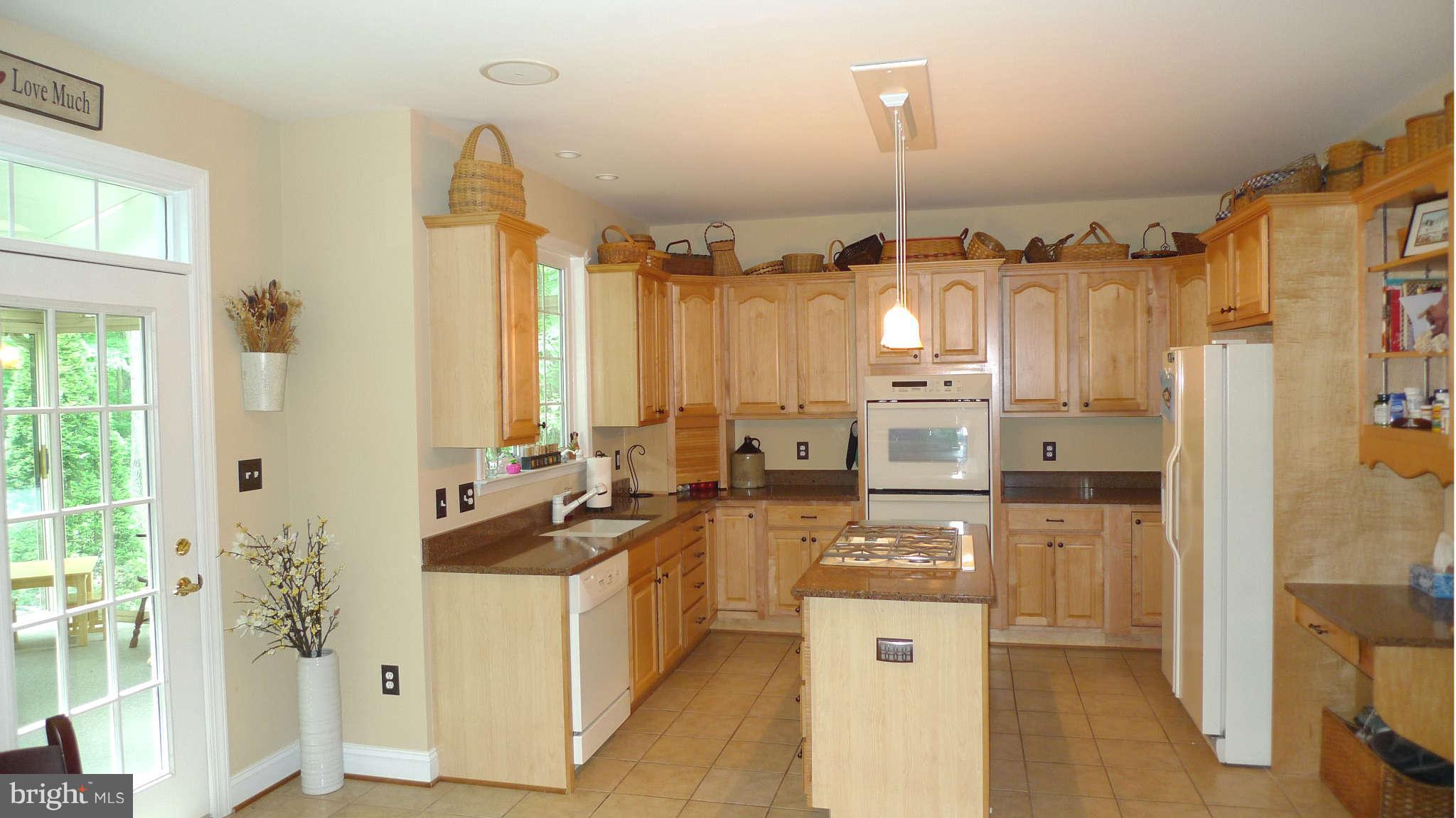 3366 Basford Road Frederick, MD 21703 - Photo 18 of 30 a kitchen with stainless steel appliances a stove a refrigerator and cabinets