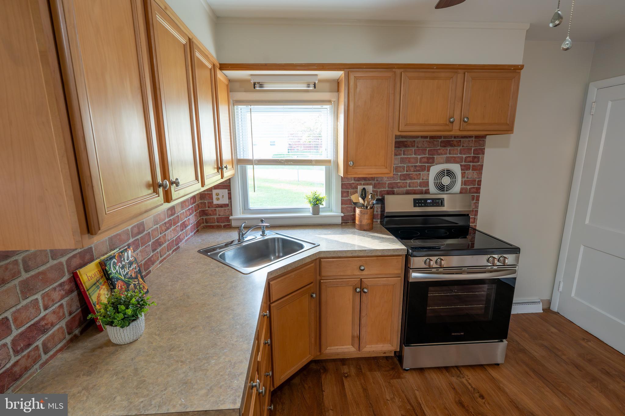 1110 Rohrerstown Road Lancaster, PA 17601 - Photo 16 of 35 a kitchen with a stove a sink and a microwave