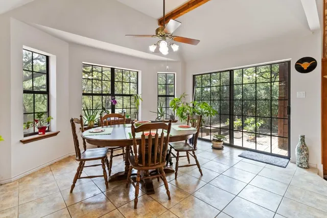 a view of a dining room with furniture a chandelier and wooden floor