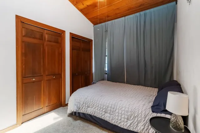 a bedroom with a bed and a dresser