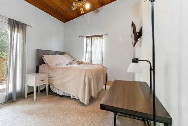 a bedroom with two beds and a window