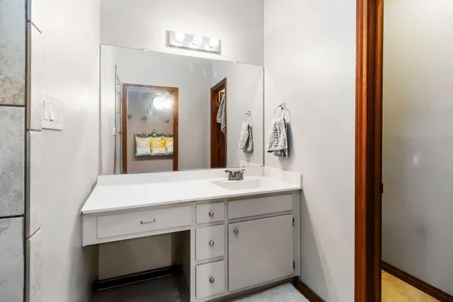 a bathroom with a sink and a mirror