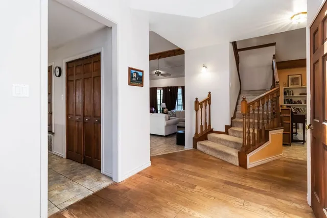 a view of a livingroom with stairs and furniture