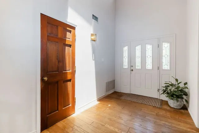 an empty room with mirror and door