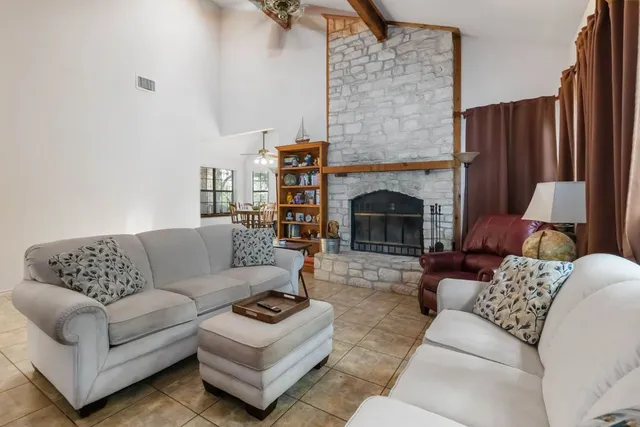 a living room with furniture and a fireplace