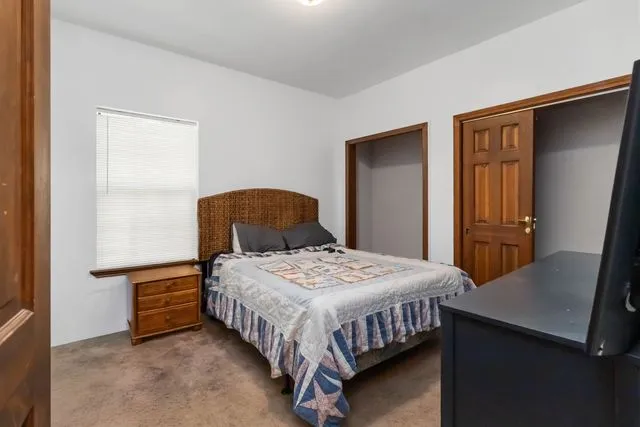 a bedroom with a bed and dresser