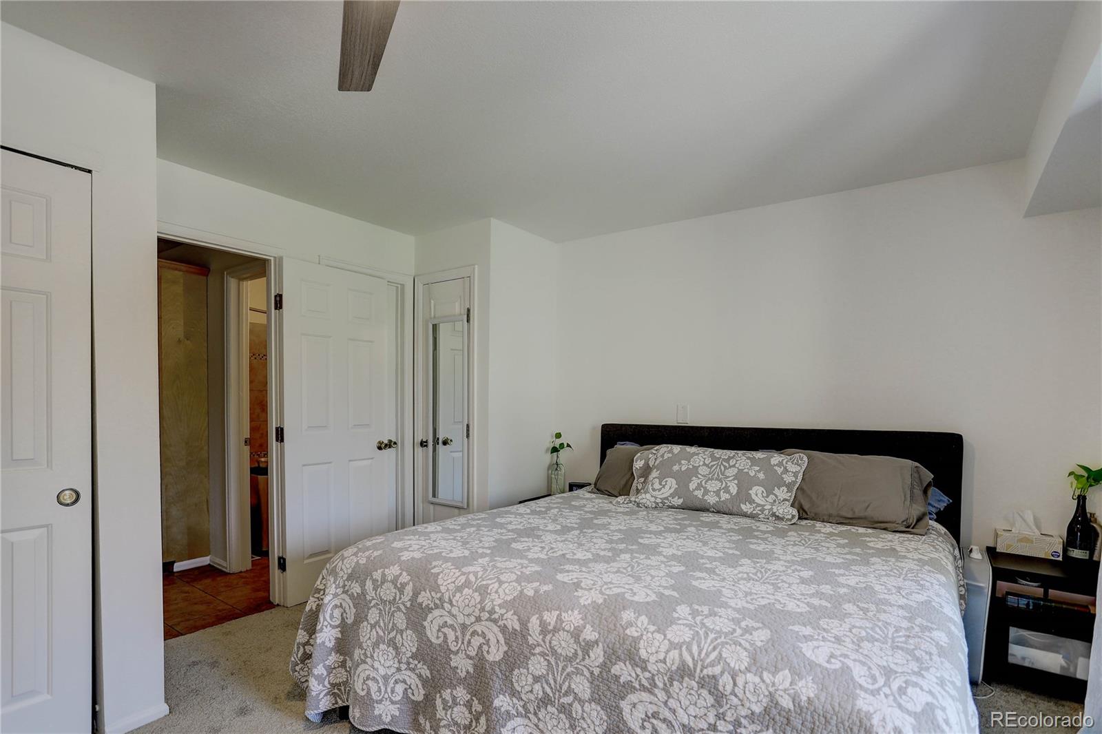 1885 South Quebec Way, Unit C15 Denver, CO 80231 - Photo 17 of 31 a bedroom with a bed and a closet