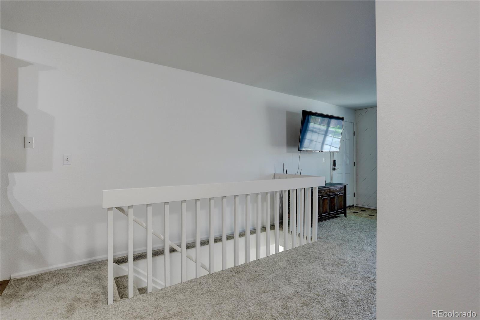 1885 South Quebec Way, Unit C15 Denver, CO 80231 - Photo 20 of 31 a view of an empty room with a staircase