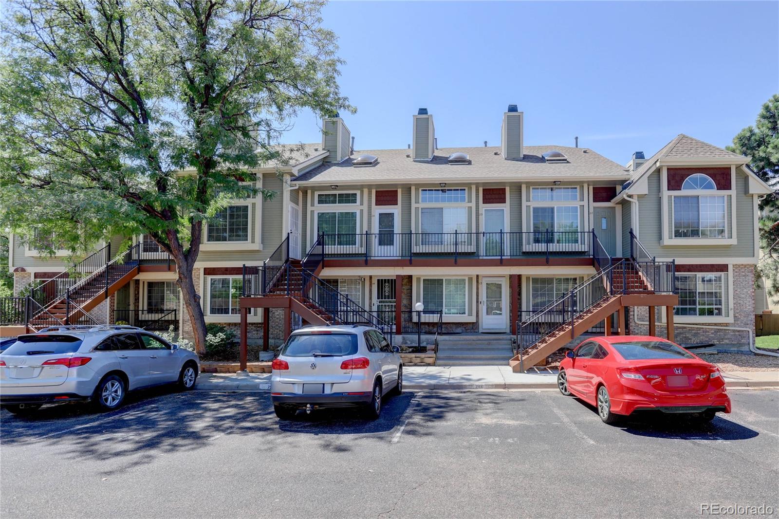 1885 South Quebec Way, Unit C15 Denver, CO 80231 - Photo 2 of 31 a front view of a building with cars parked