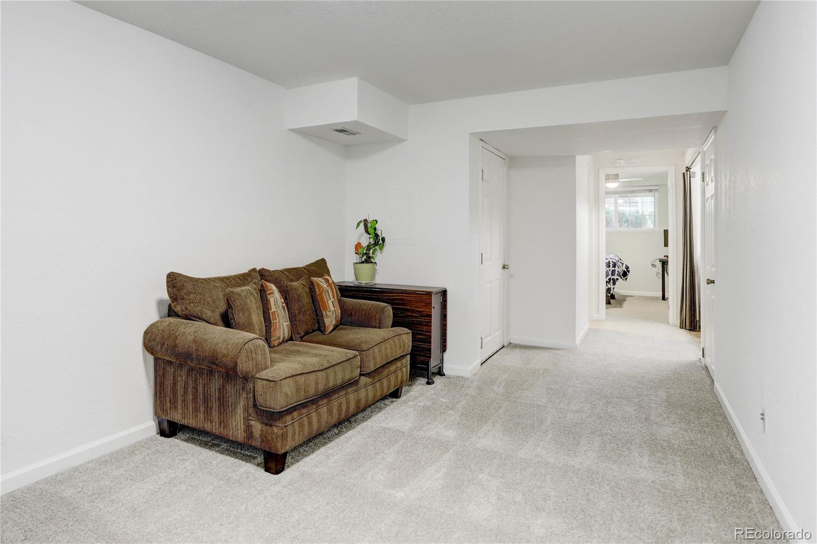 1885 South Quebec Way, Unit C15 Denver, CO 80231 - Photo 21 of 31 a living room with furniture and a walk in closet
