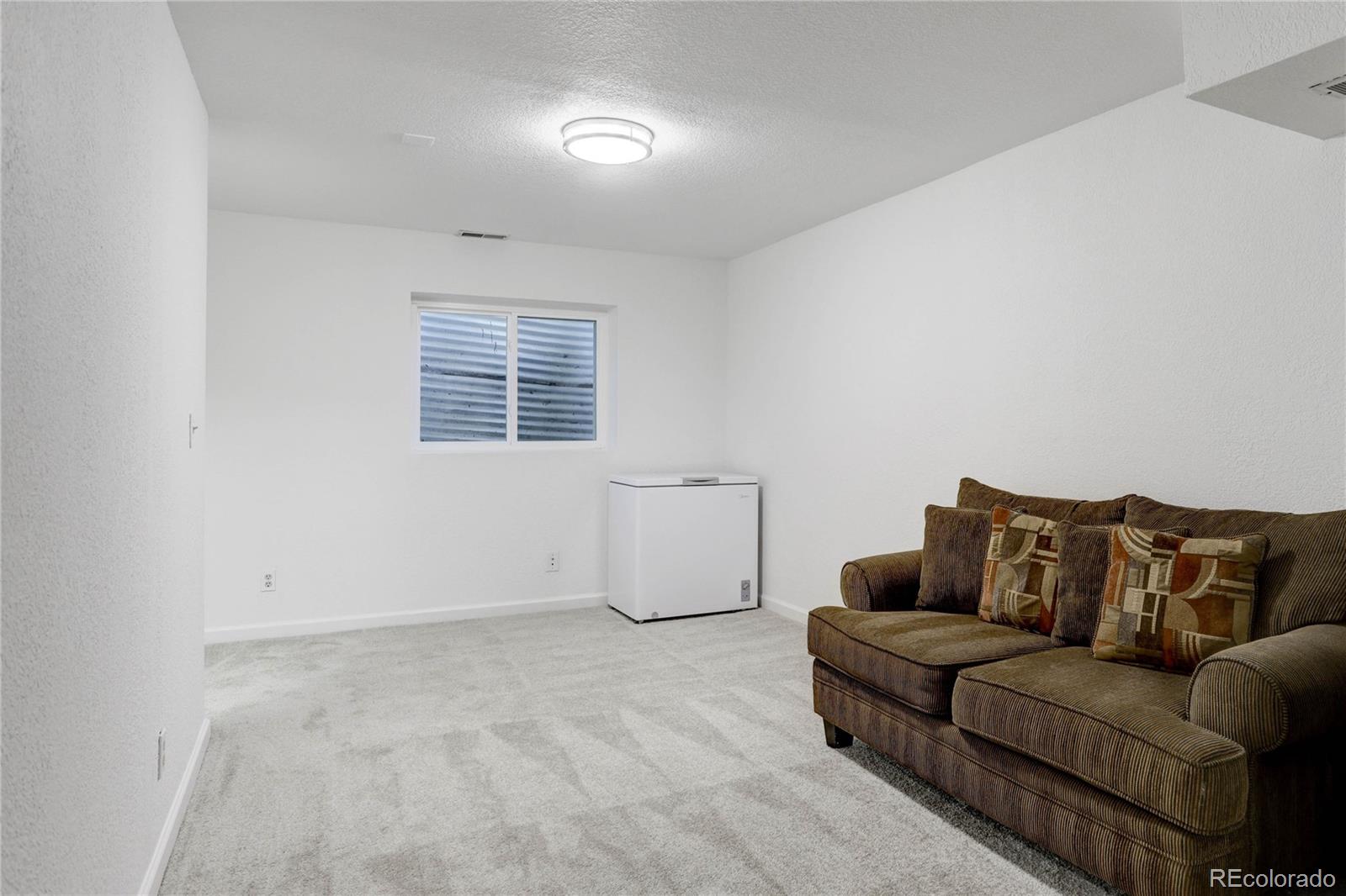 1885 South Quebec Way, Unit C15 Denver, CO 80231 - Photo 22 of 31 a living room with furniture and a window