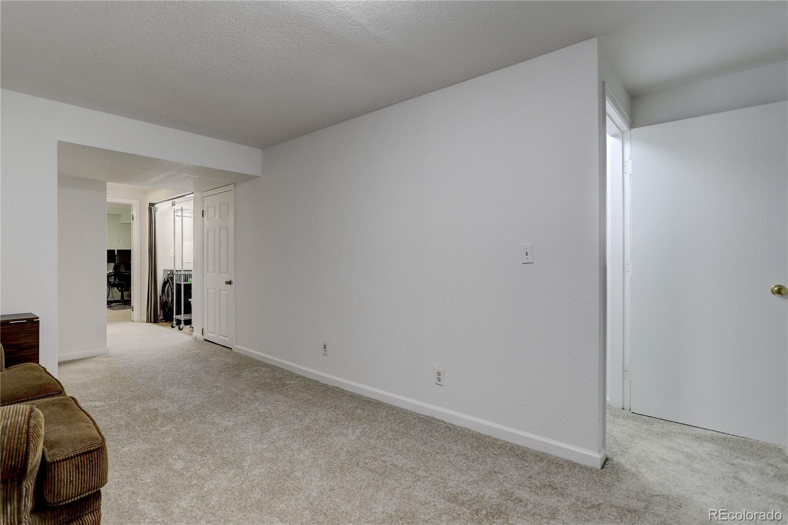 1885 South Quebec Way, Unit C15 Denver, CO 80231 - Photo 23 of 31 a view of a livingroom with a dresser