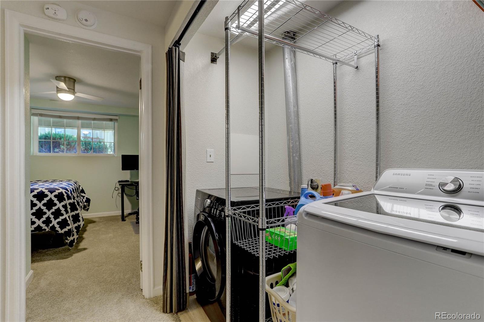 1885 South Quebec Way, Unit C15 Denver, CO 80231 - Photo 24 of 31 a bathroom with a sink and mirror with bathtub