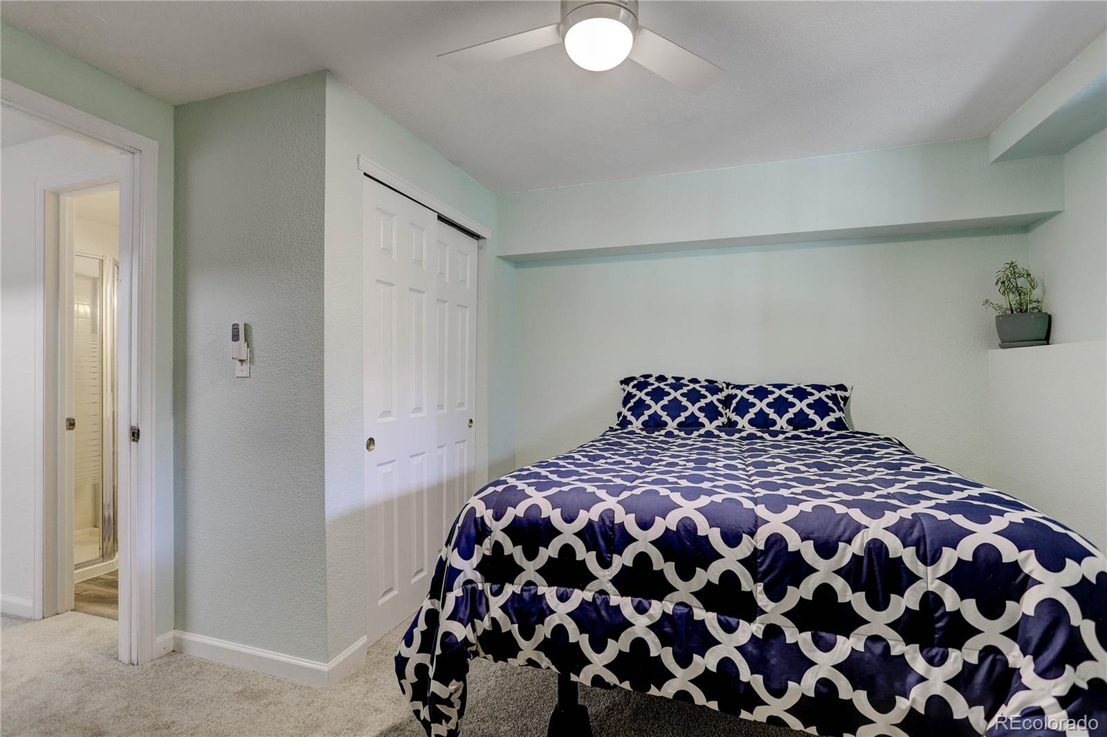 1885 South Quebec Way, Unit C15 Denver, CO 80231 - Photo 26 of 31 a large bed sitting in a bedroom next to a window and a dresser