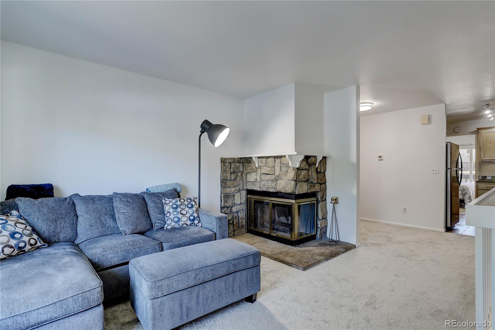 1885 South Quebec Way, Unit C15 Denver, CO 80231 - Photo 6 of 31 a living room with furniture and a fireplace