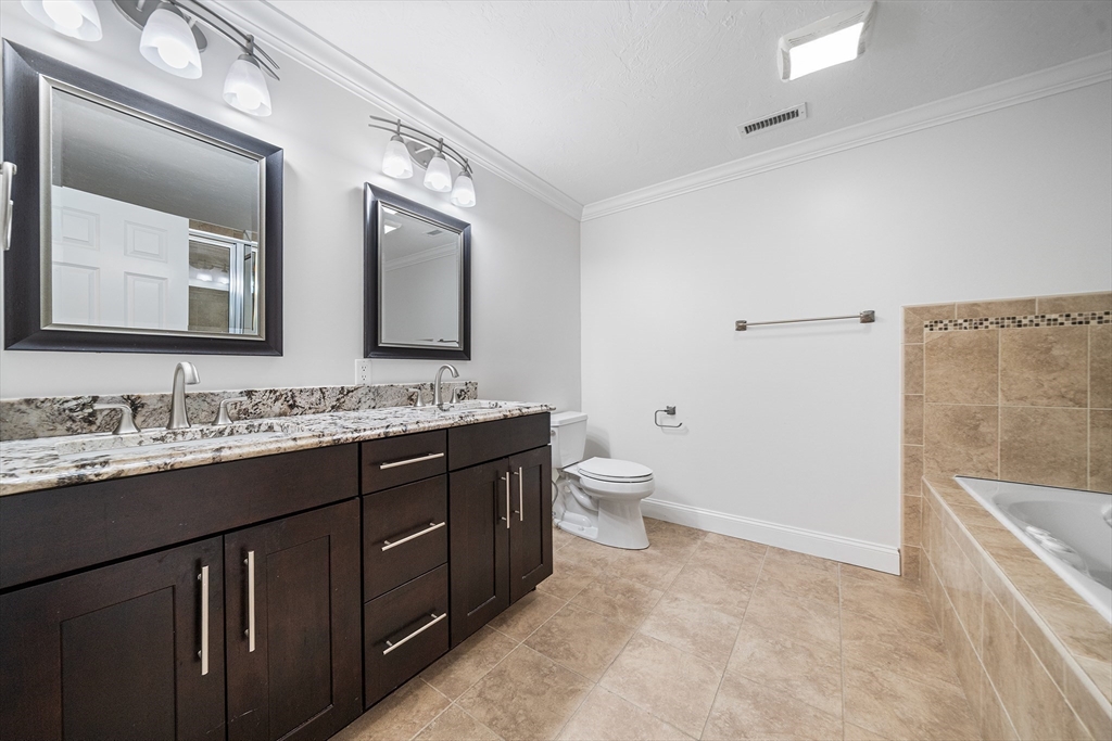 215 Rangeway Road, Unit 31 Billerica, MA 01862 - Photo 20 of 40 a bathroom with a granite countertop sink mirror and toilet