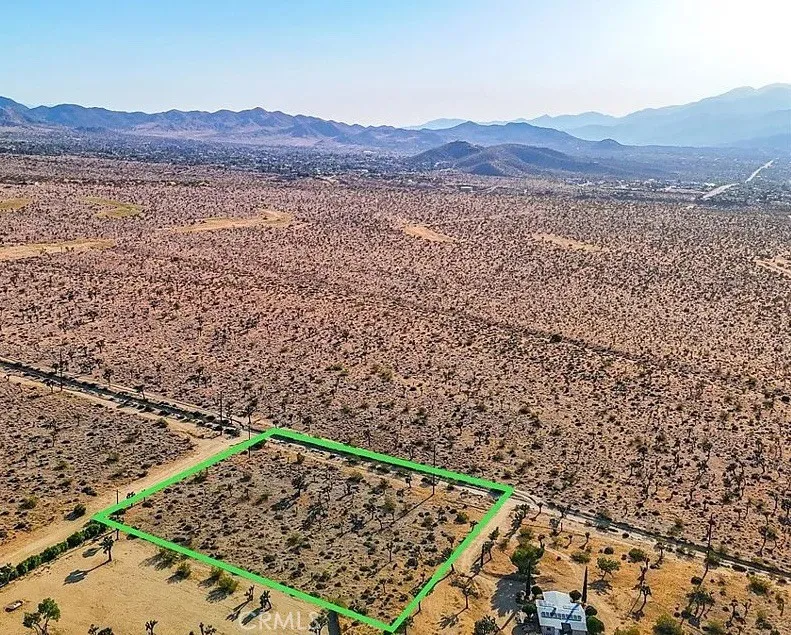 7645 La Contenta Road Yucca Valley, CA 92284 - Photo 6 of 14 a view of a lush green field with mountains in the background