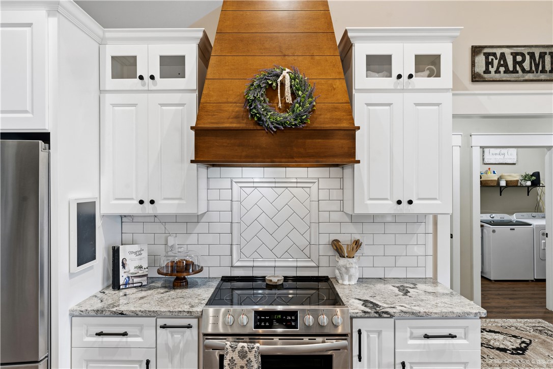 1158 Pyle Road Clarksville, OH 45113 - Photo 24 of 76 This modern kitchen features crisp cabinetry, granite countertops, and a subway tile backsplash with a unique herringbone detail.