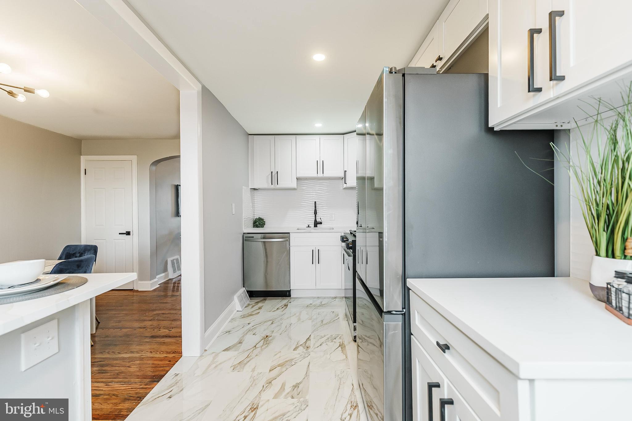 1620 Ashurst Road Philadelphia, PA 19151 - Photo 11 of 30 a kitchen with a sink a stove a refrigerator and cabinets