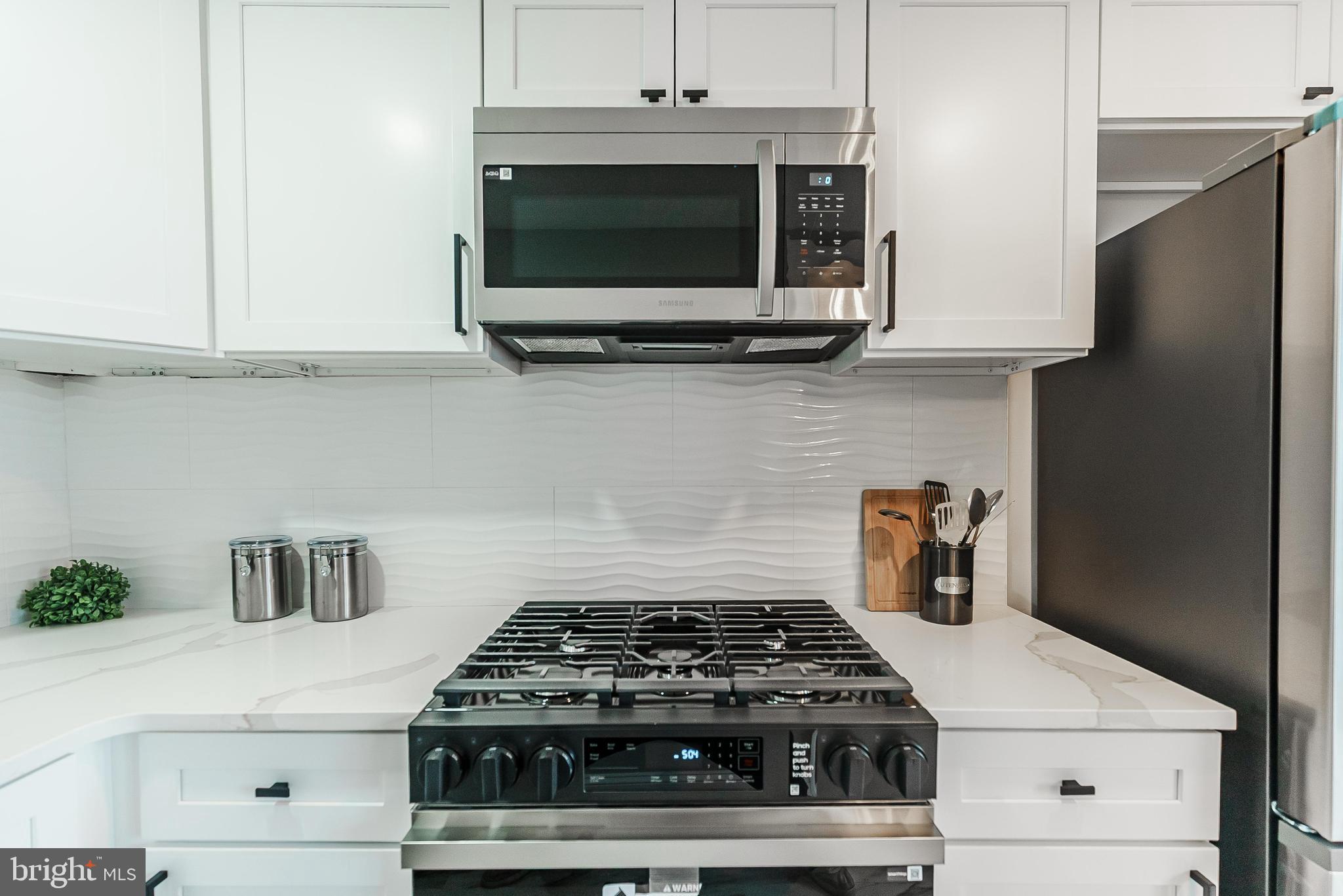 1620 Ashurst Road Philadelphia, PA 19151 - Photo 15 of 30 a stove top oven sitting inside of a kitchen