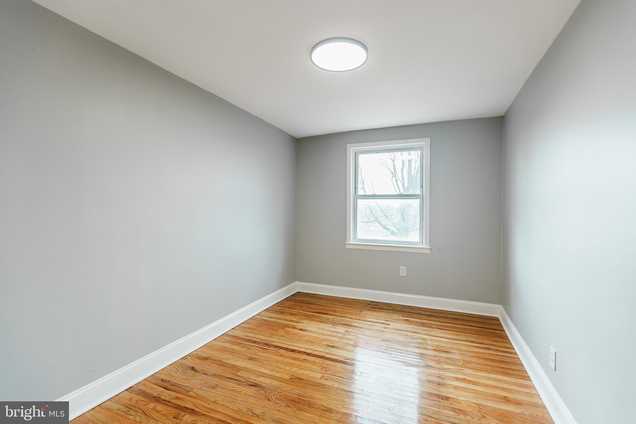 1620 Ashurst Road Philadelphia, PA 19151 - Photo 22 of 30 a view of empty room with wooden floor and fan