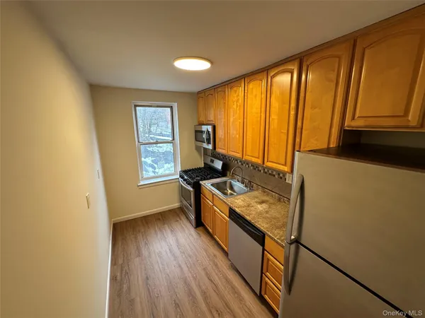 a kitchen with a stove a sink and a refrigerator