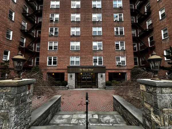 a view of a brick building with many windows