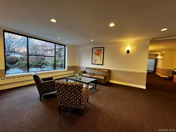 a living room with furniture and a pool table
