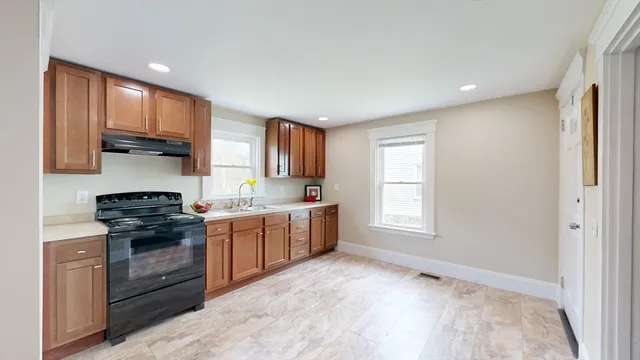 a kitchen with a stove a sink and a microwave