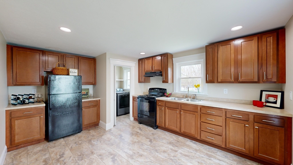 262 Plymouth Street, Unit 1 Bridgewater, MA 02324 - Photo 15 of 26 a kitchen with stainless steel appliances granite countertop a refrigerator stove and sink