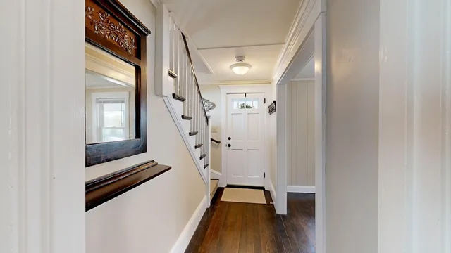 a view of entryway and hall with wooden floor