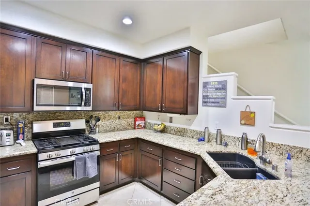 a kitchen with a sink stove and microwave