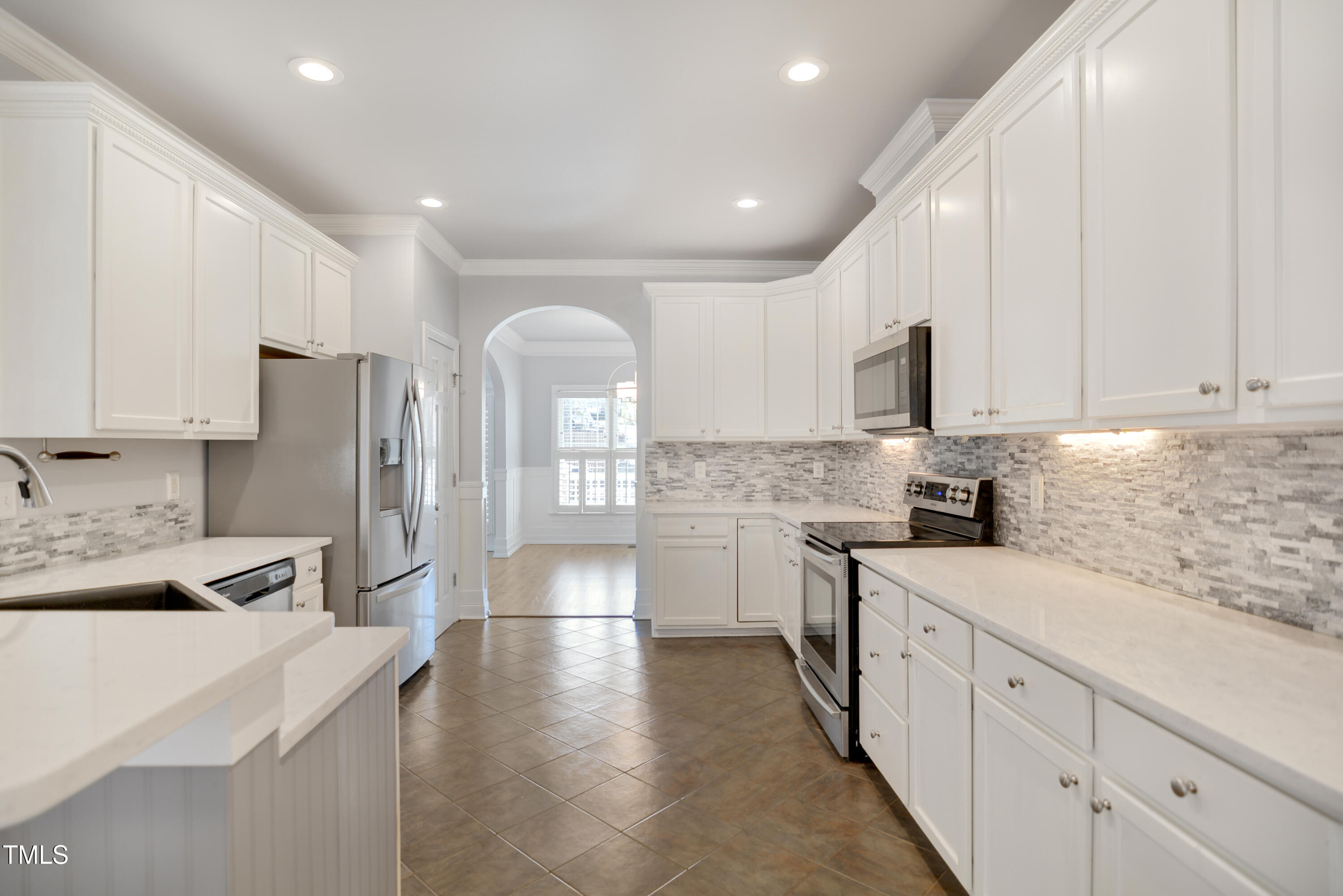 121 Homegate Circle Apex, NC 27502 - Photo 11 of 33 a kitchen with granite countertop white cabinets and white appliances