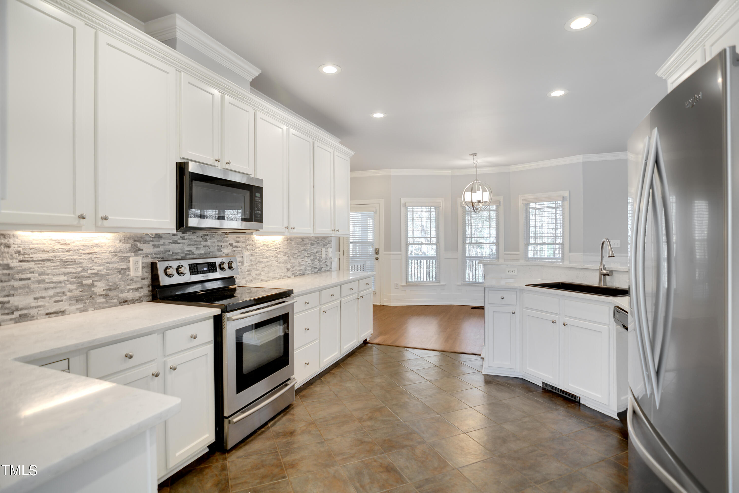 121 Homegate Circle Apex, NC 27502 - Photo 12 of 33 a large kitchen with cabinets stainless steel appliances and a counter top space
