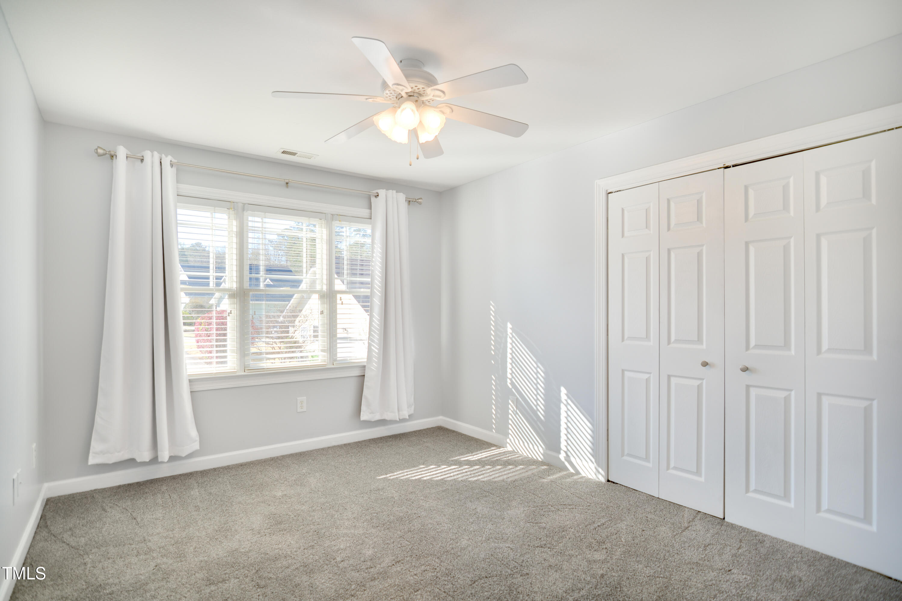 121 Homegate Circle Apex, NC 27502 - Photo 19 of 33 a view of an empty room with a window