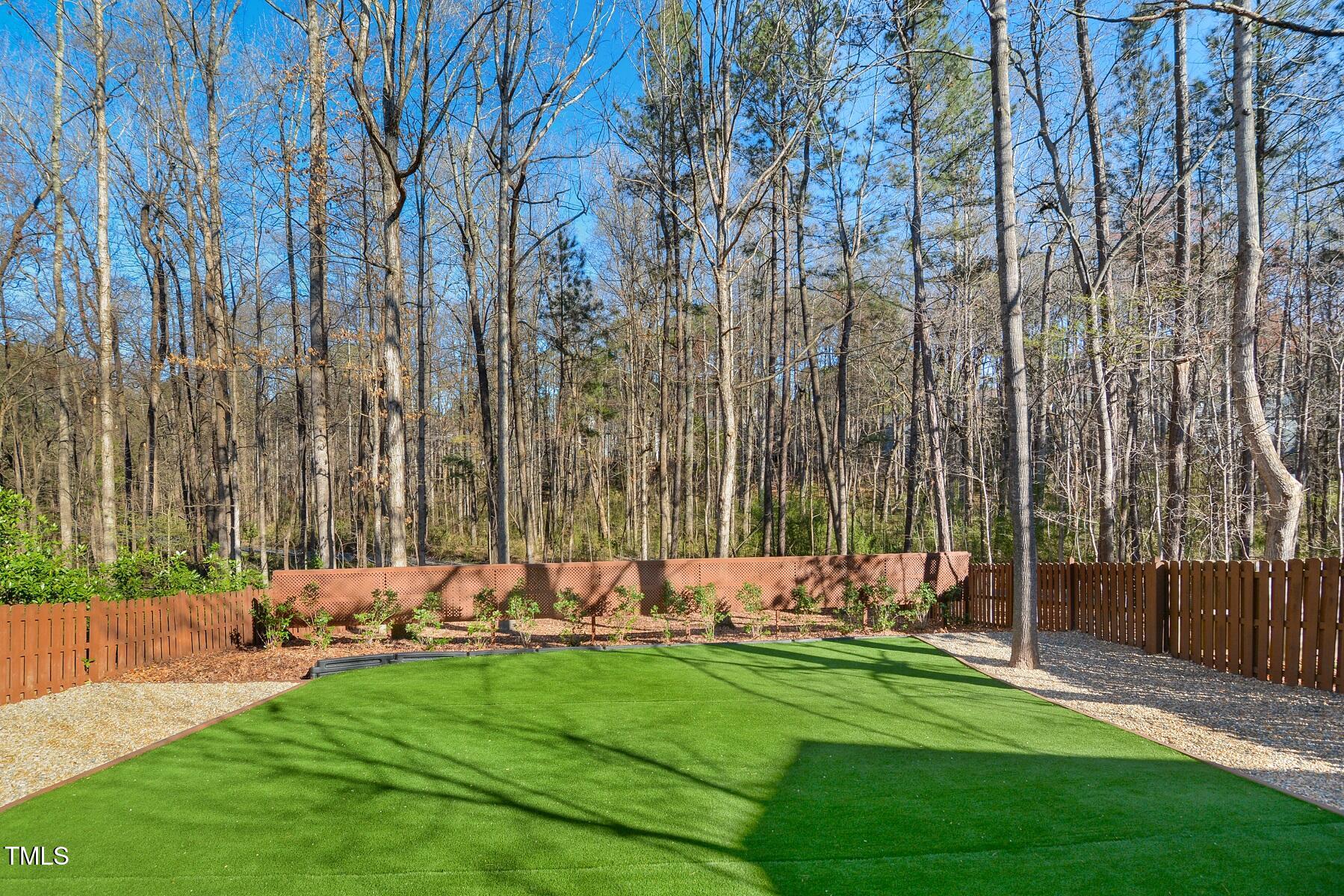 121 Homegate Circle Apex, NC 27502 - Photo 31 of 33 a view of a backyard with a bench and trees